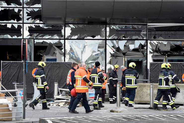 Illustration picture shows members of the civil protection outside the damaged front of Brussels Airport, in Zaventem, Wednesday 23 March 2016. Yesterday morning two bombs exploded in the departure hall of Brussels Airport and another one in the Maelbeek - Maalbeek subway station, which made around 30 deadly victims and 230 injured people in total. ISIL (Islamic State of Iraq and the Levant - Daesh) claimed responsibility for these attacks. The terrorist threat level has been heightened to four across the country. BELGA PHOTO YORICK JANSENS (C) BELGA